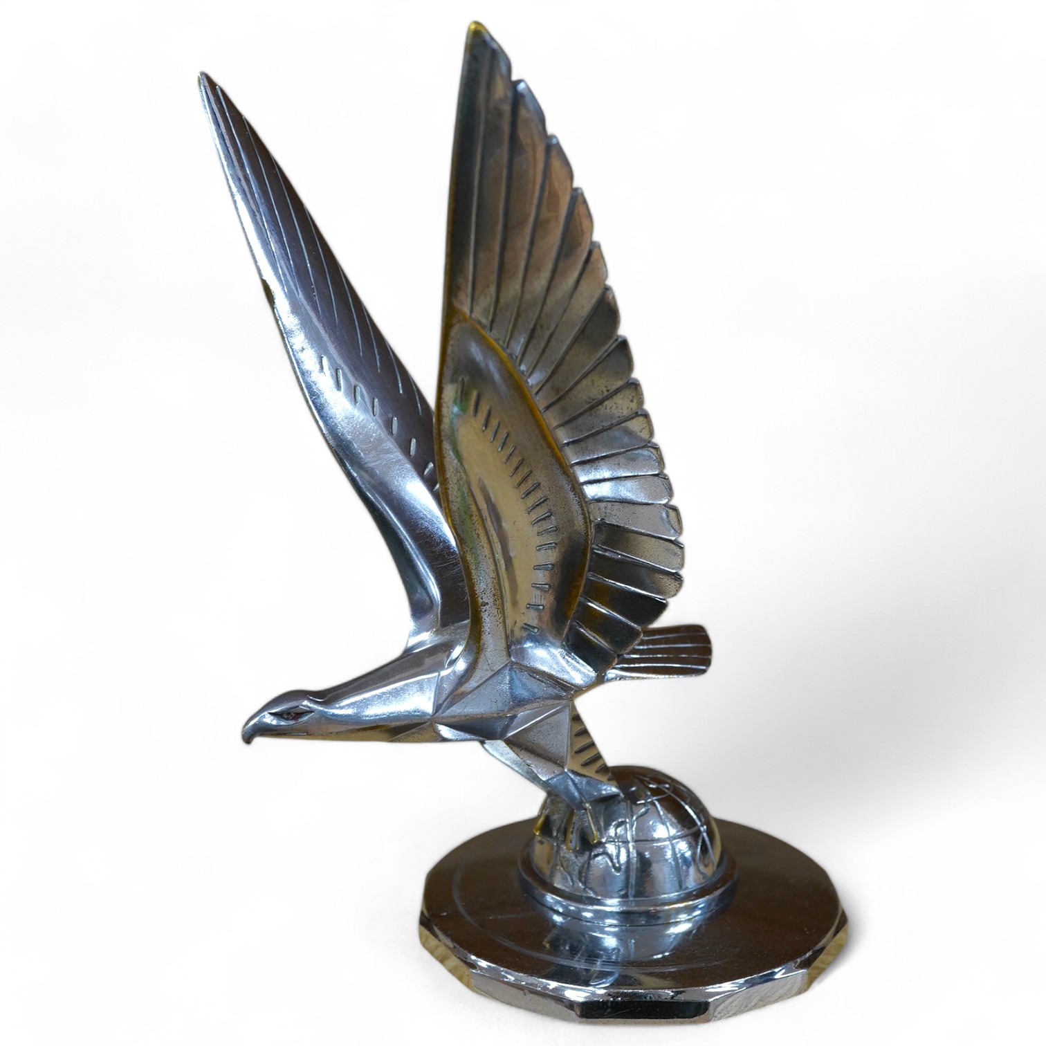 A 1920s/30s French Art Deco ‘eagle on a globe’ car mascot by Casimir Brau for the car manufacturer Messier, mounted to a threaded radiator cap, height 23cm. Condition - good.